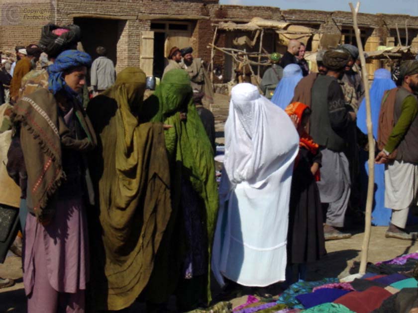 Man and Women in Burkas Shopping